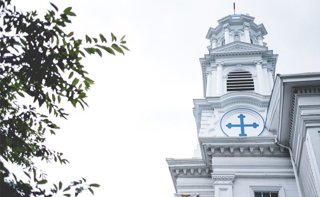 artistic shot of Highrock Arlington steeple against a white sky