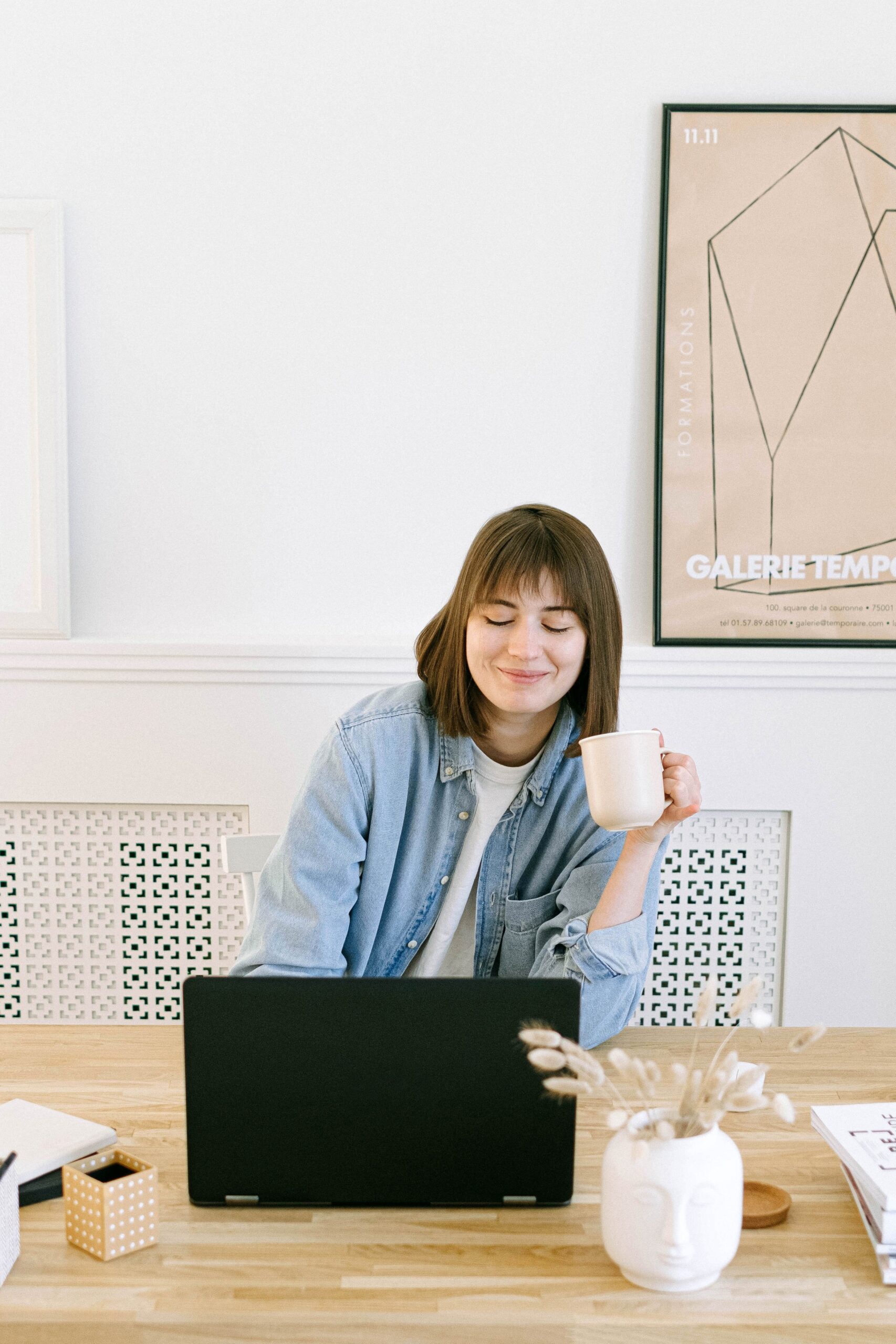 woman using laptop with coffee